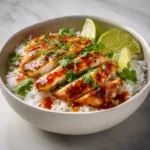 Honey lime chicken served over rice with cilantro and lime